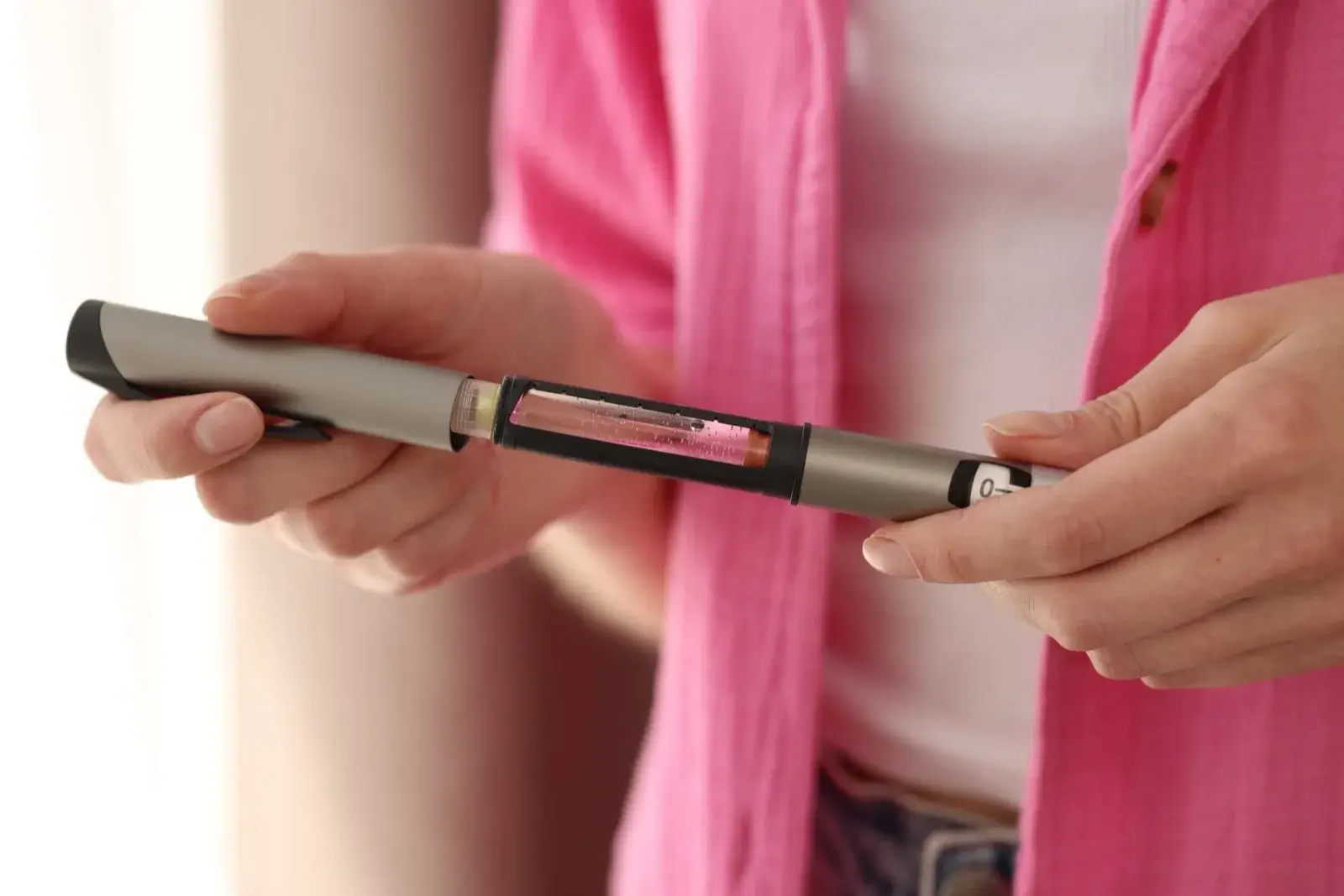 Woman using an injectable medication pen at home