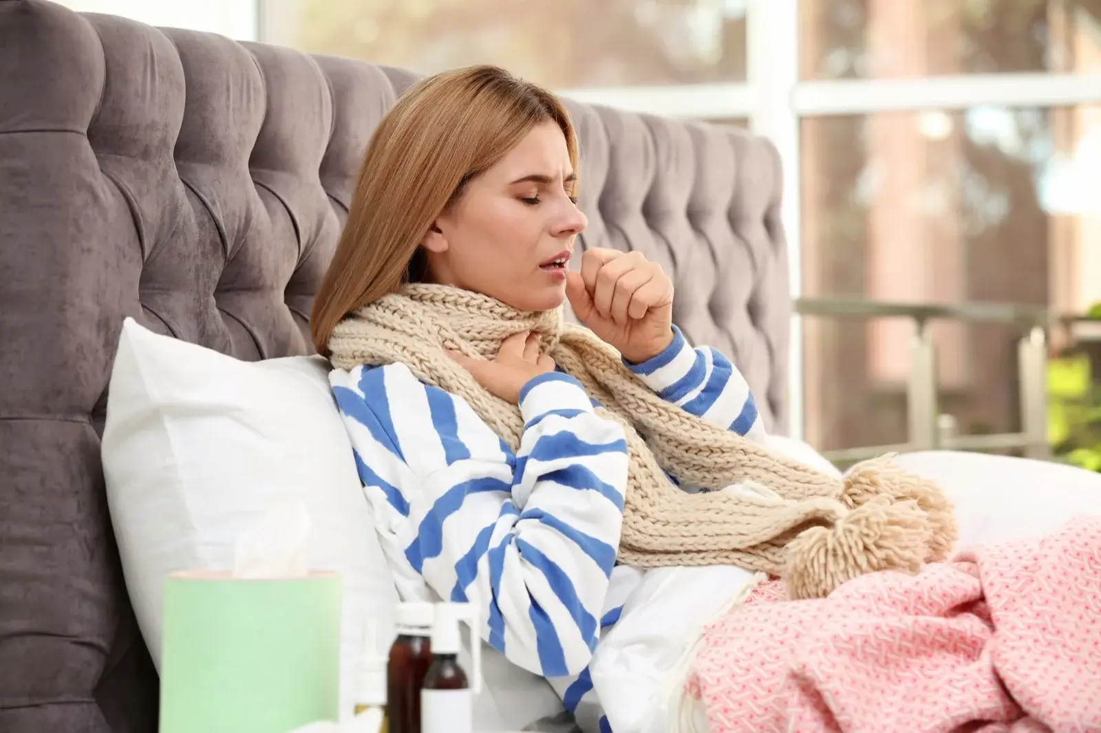 Woman resting in bed while recovering from illness