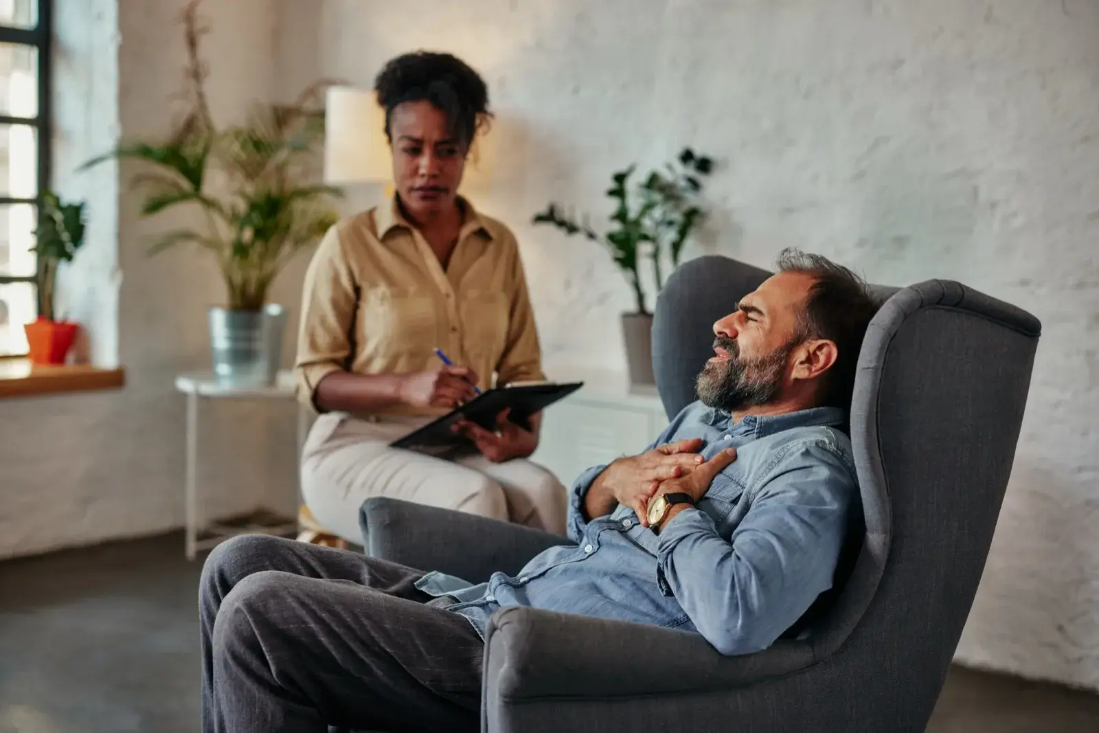 Counselor listening to a patient during a therapy session